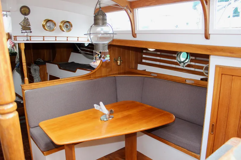 Slide: The Image of Interior of 1975 William Garden Porpoise boat with wooden dining area and nautical decor. - 16