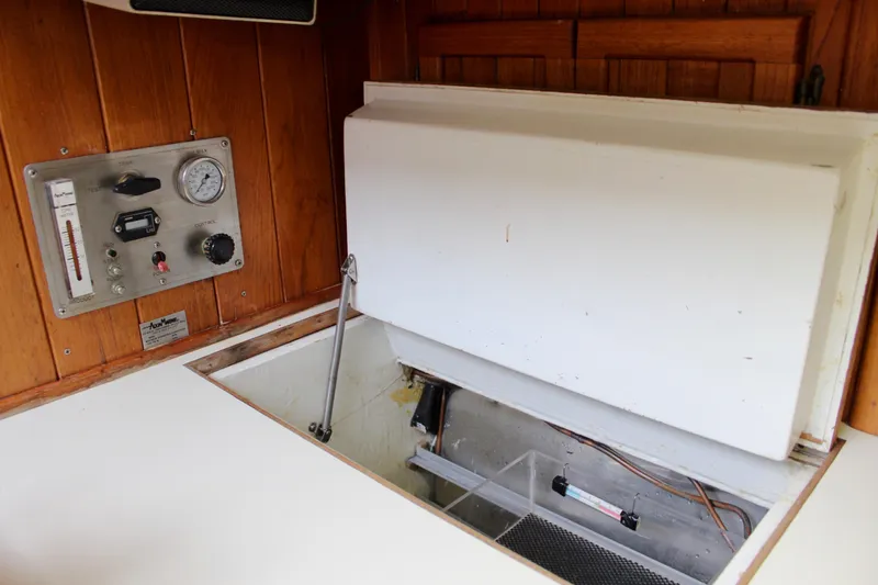 Slide: The Image of 1975 William Garden Porpoise interior with control panel and storage compartment. - 21