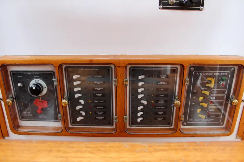 Slide: The Image of Electrical control panel on a 1975 William Garden Porpoise boat, featuring switches and dials. - 26