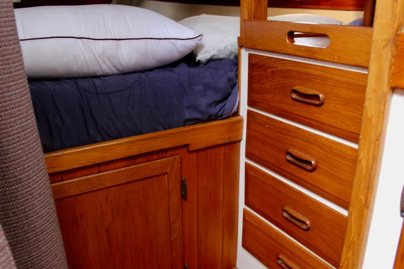 Slide: The Image of Cozy cabin interior of 1975 William Garden Porpoise with wooden drawers and bedding. - 27