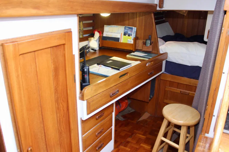 Slide: The Image of Cozy 1975 William Garden Porpoise yacht interior with wooden desk and storage. - 29