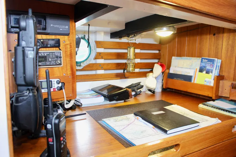 Slide: The Image of Navigation station inside a 1975 William Garden Porpoise boat, featuring communication equipment and charts. - 30