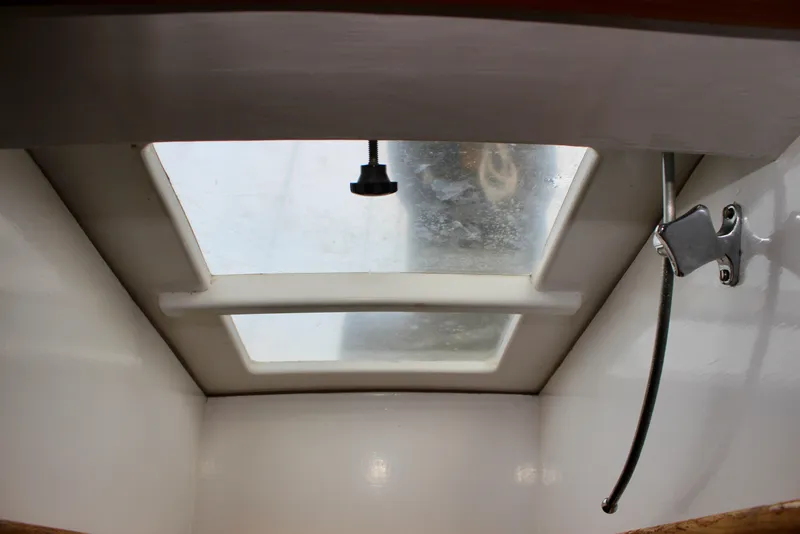 Slide: The Image of Interior view of a 1975 William Garden Porpoise sailboat hatch with a locking mechanism. - 38
