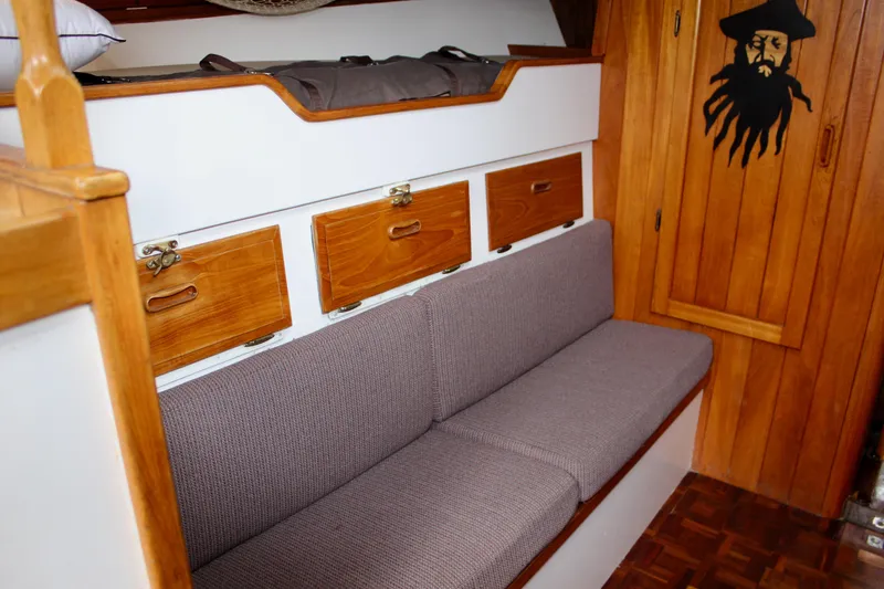 Slide: The Image of Cozy 1975 William Garden Porpoise boat interior with wooden cabinets and cushioned seating. - 39