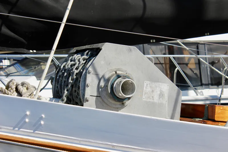 Slide: The Image of Anchor windlass on 1975 William Garden Porpoise sailboat, featuring chain and rope. - 4