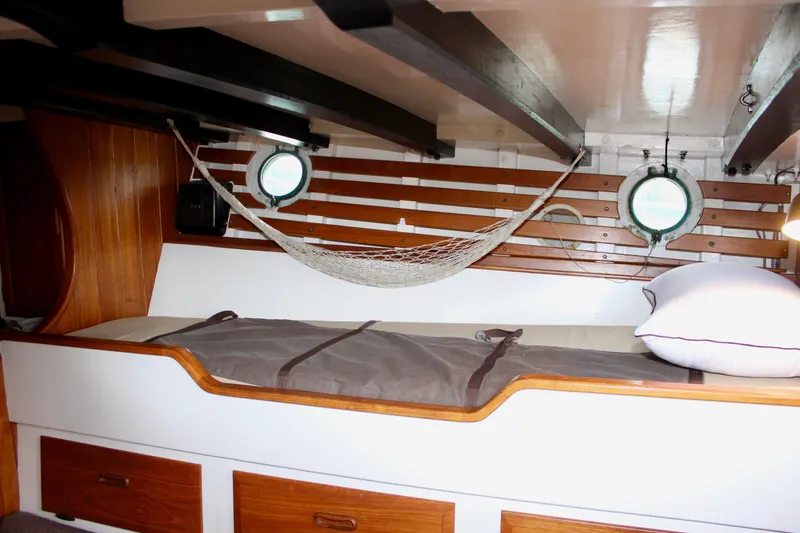 Slide: The Image of Cozy cabin interior of 1975 William Garden Porpoise boat with hammock and porthole. - 41
