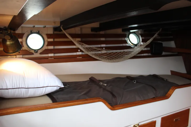 Slide: The Image of Cozy cabin interior of 1975 William Garden Porpoise boat with hammock and porthole. - 42