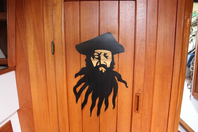 Slide: The Image of Wooden door with pirate silhouette on 1975 William Garden Porpoise boat. - 45