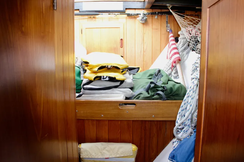 Slide: The Image of Cozy cabin interior of 1975 William Garden Porpoise sailboat with storage and nautical gear. - 50