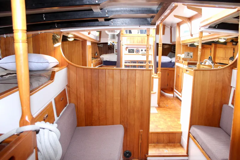 Slide: The Image of Interior of 1975 William Garden Porpoise yacht with wooden paneling and cozy seating. - 52