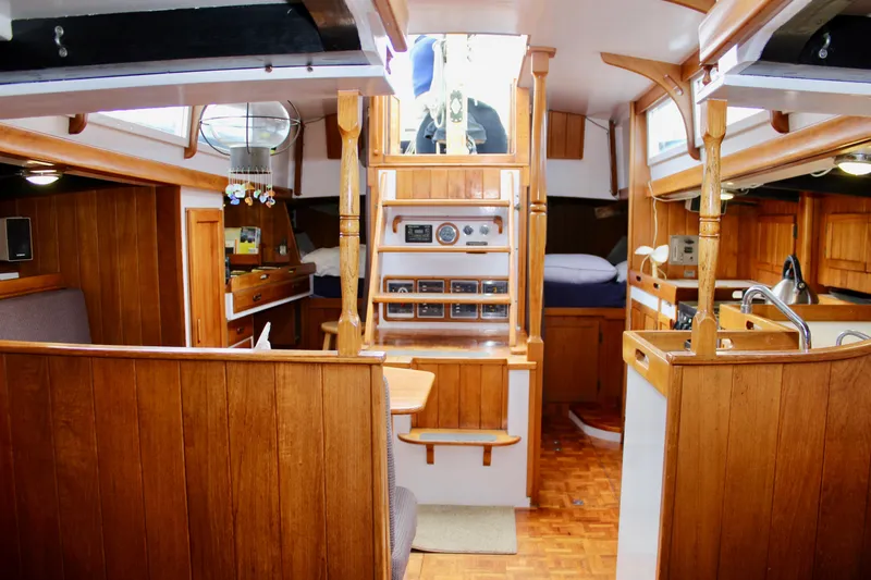 Slide: The Image of Interior of a 1975 William Garden Porpoise sailboat with wooden furnishings and cozy cabin layout. - 53