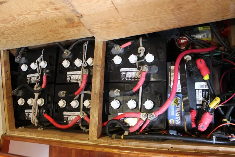 Slide: The Image of Battery compartment of a 1975 William Garden Porpoise boat, featuring multiple connected batteries. - 58
