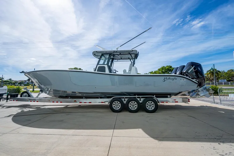 The Image of 2026 Yellowfin 36 Offshore boat on a trailer, parked outdoors under a clear sky. - 0