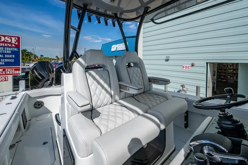 Slide: The Image of 2026 Yellowfin 36 Offshore boat interior with luxurious seating and modern steering console. - 13