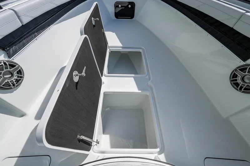 Slide: The Image of 2026 Yellowfin 36 Offshore boat storage compartments with open hatches and speakers. - 24