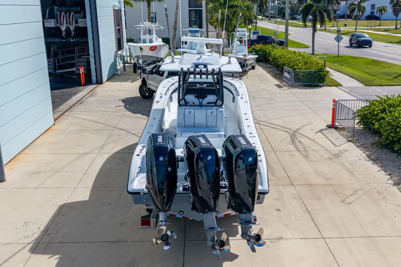 Slide: The Image of 2026 Yellowfin 36 Offshore boat with triple outboard engines in a marina setting. - 3