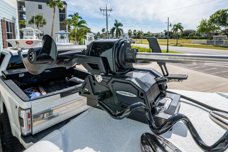 Slide: The Image of 2026 Yellowfin 36 Offshore boat with Power-Pole anchor system, parked near palm trees. - 30