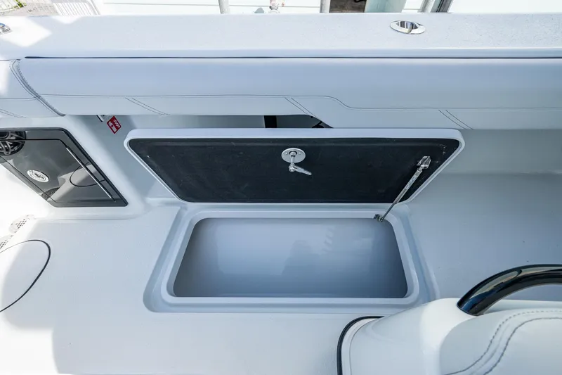 Slide: The Image of 2026 Yellowfin 36 Offshore boat storage compartment with open lid and secure latch. - 37