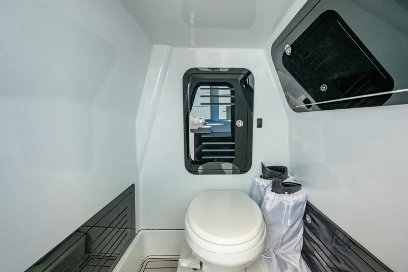 Slide: The Image of 2026 Yellowfin 36 Offshore boat interior bathroom with modern design and compact toilet. - 38