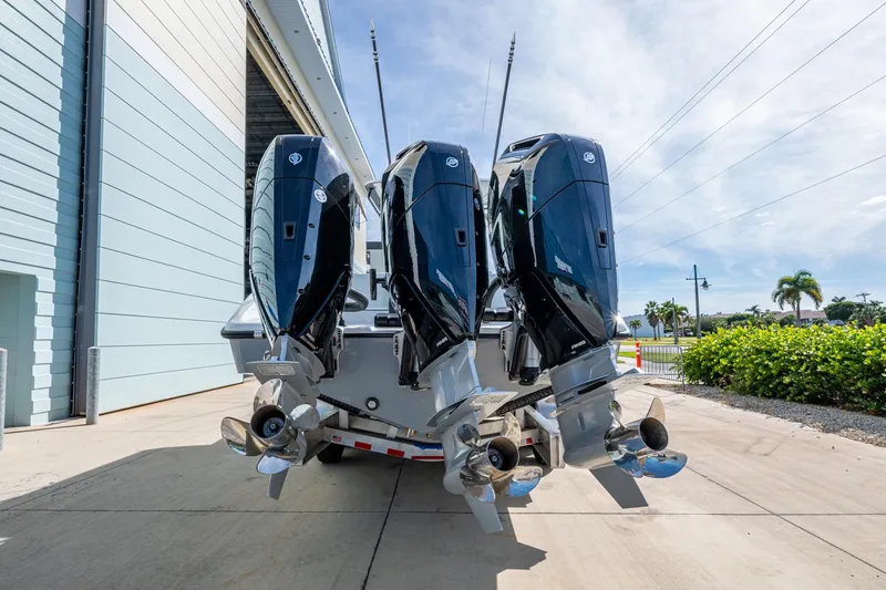 Slide: The Image of 2026 Yellowfin 36 Offshore boat with four powerful outboard engines, docked outdoors. - 5