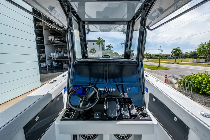 Slide: The Image of 2026 Yellowfin 36 Offshore boat cockpit with modern controls and steering wheel. - 7