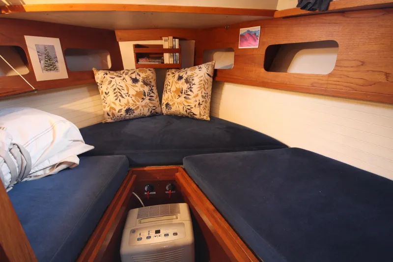 Slide: The Image of Cozy cabin interior of 1984 Nauticat 33 sailboat with blue cushions and wooden accents. - 24