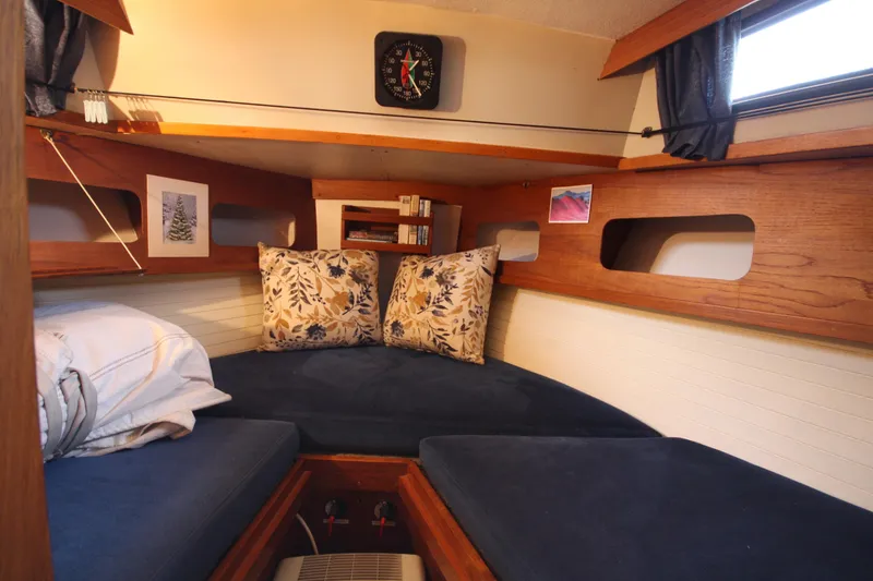Slide: The Image of Cozy cabin interior of 1984 Nauticat 33 sailboat with cushions and wooden accents. - 25