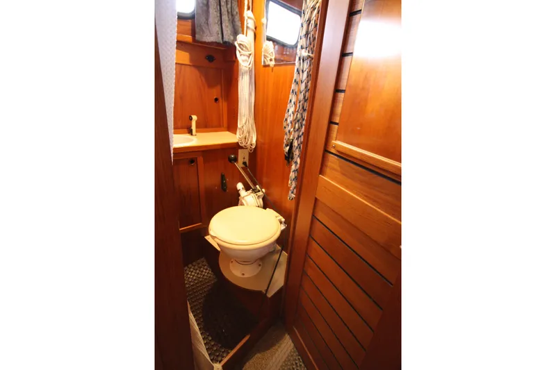 Slide: The Image of 1984 Nauticat 33 boat bathroom with wooden interior and compact design. - 28