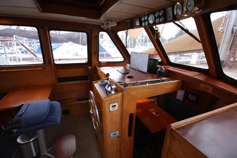Slide: The Image of Interior of 1984 Nauticat 33 sailboat cockpit with navigation equipment and wooden finish. - 3