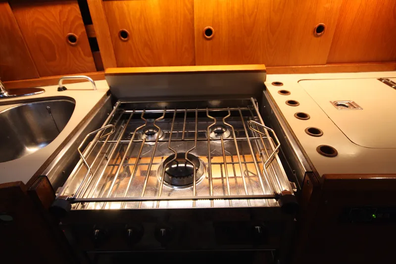 Slide: The Image of Stainless steel stove in 1984 Nauticat 33 yacht kitchen with wooden cabinetry. - 34