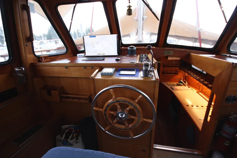 Slide: The Image of Interior of 1984 Nauticat 33 sailboat with wooden helm and navigation equipment. - 4