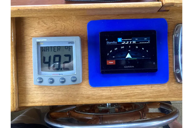Slide: The Image of Control panel of a 1984 Nauticat 33 with Raymarine and Garmin displays. - 43