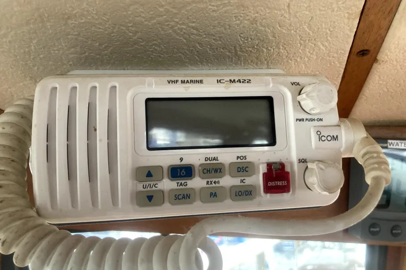 Slide: The Image of VHF marine radio IC-M422 on 1984 Nauticat 33 boat, featuring distress button and controls. - 45