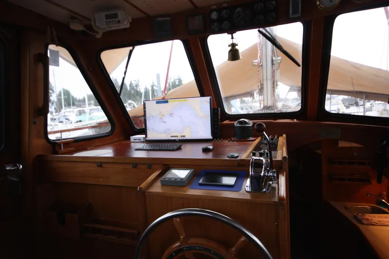 Slide: The Image of Interior of 1984 Nauticat 33 sailboat cockpit with navigation equipment and steering wheel. - 5