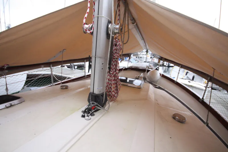 Slide: The Image of 1984 Nauticat 33 sailboat deck with rigging and tan sails. - 50