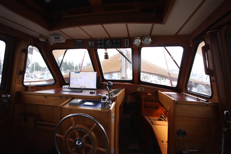 Slide: The Image of Interior of 1984 Nauticat 33 sailboat cockpit with navigation equipment and wooden finish. - 7