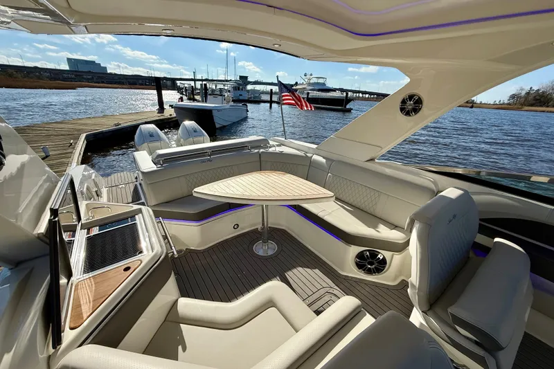 Slide: The Image of Luxurious 2021 Sea Ray SLX 310 Outboard boat interior with seating and table. - 19