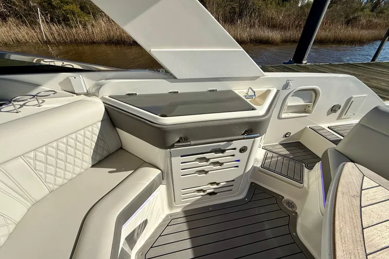 Slide: The Image of Luxurious interior of 2021 Sea Ray SLX 310 Outboard with seating and kitchenette. - 22