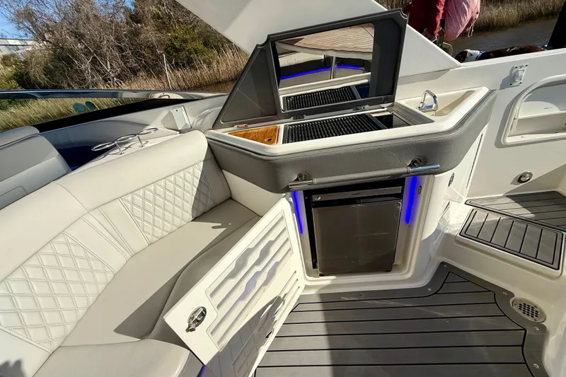 Slide: The Image of Interior view of 2021 Sea Ray SLX 310 Outboard, featuring luxurious seating and modern dashboard. - 23