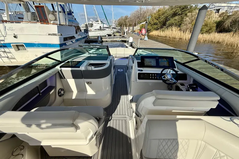Slide: The Image of 2021 Sea Ray SLX 310 Outboard interior with luxurious seating and sleek design. - 24