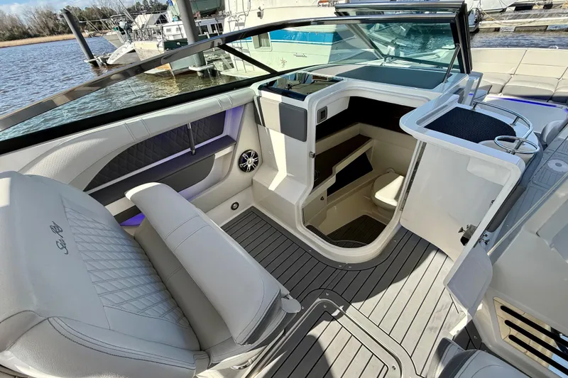 Slide: The Image of 2021 Sea Ray SLX 310 Outboard interior with sink, toilet, and modern design. - 26