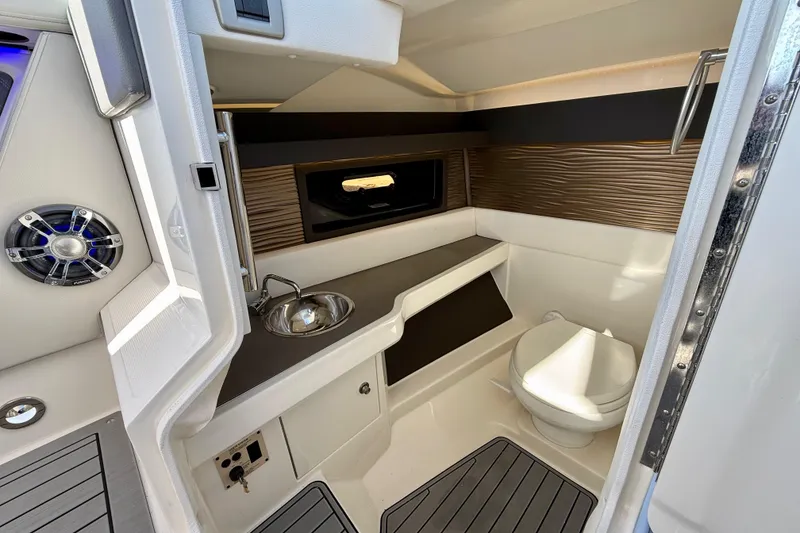 Slide: The Image of 2021 Sea Ray SLX 310 Outboard boat interior with helm, seating, and modern controls. - 27