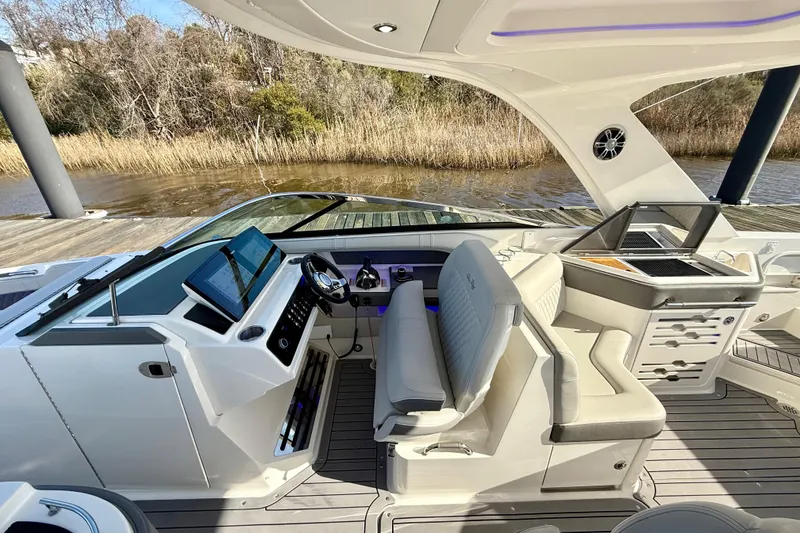 Slide: The Image of 2021 Sea Ray SLX 310 Outboard helm with modern controls and navigation display. - 28