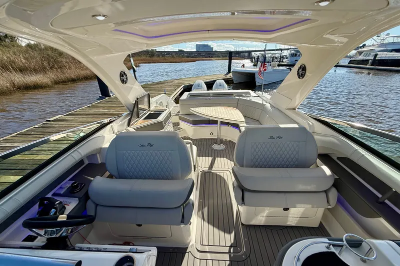 Slide: The Image of 2021 Sea Ray SLX 310 Outboard boat docked, featuring spacious seating and sleek design. - 31