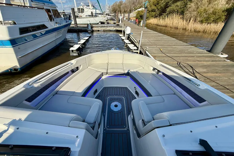 Slide: The Image of 2021 Sea Ray SLX 310 Outboard boat interior with spacious seating at dock. - 33