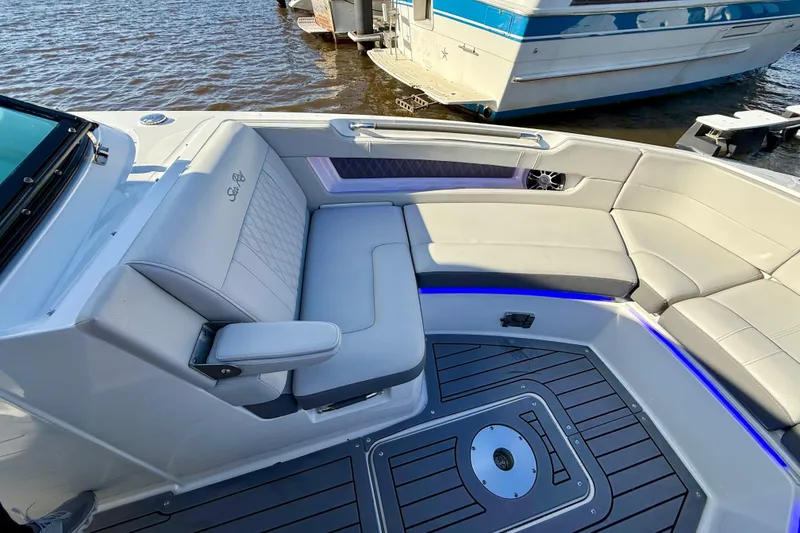Slide: The Image of 2021 Sea Ray SLX 310 Outboard boat interior with luxurious seating and modern design. - 35