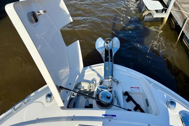 Slide: The Image of 2021 Sea Ray SLX 310 Outboard anchor compartment with open hatch, dockside view. - 36