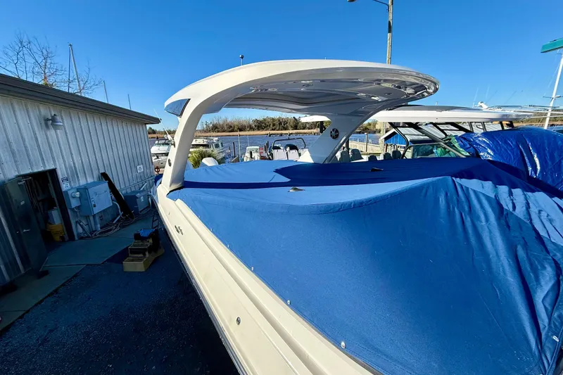 Slide: The Image of 2021 Sea Ray SLX 310 Outboard boat covered with blue tarp at marina. - 39