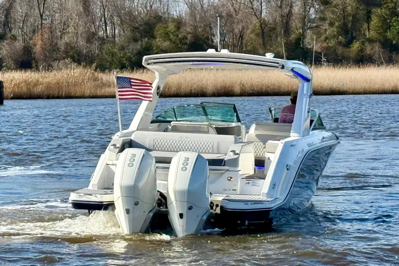 Slide: The Image of 2021 Sea Ray SLX 310 Outboard cruising on a scenic river. - 5