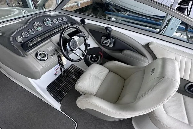 Slide: The Image of Interior of 2011 Cobalt 242 WSS boat with steering wheel and dashboard controls. - 10